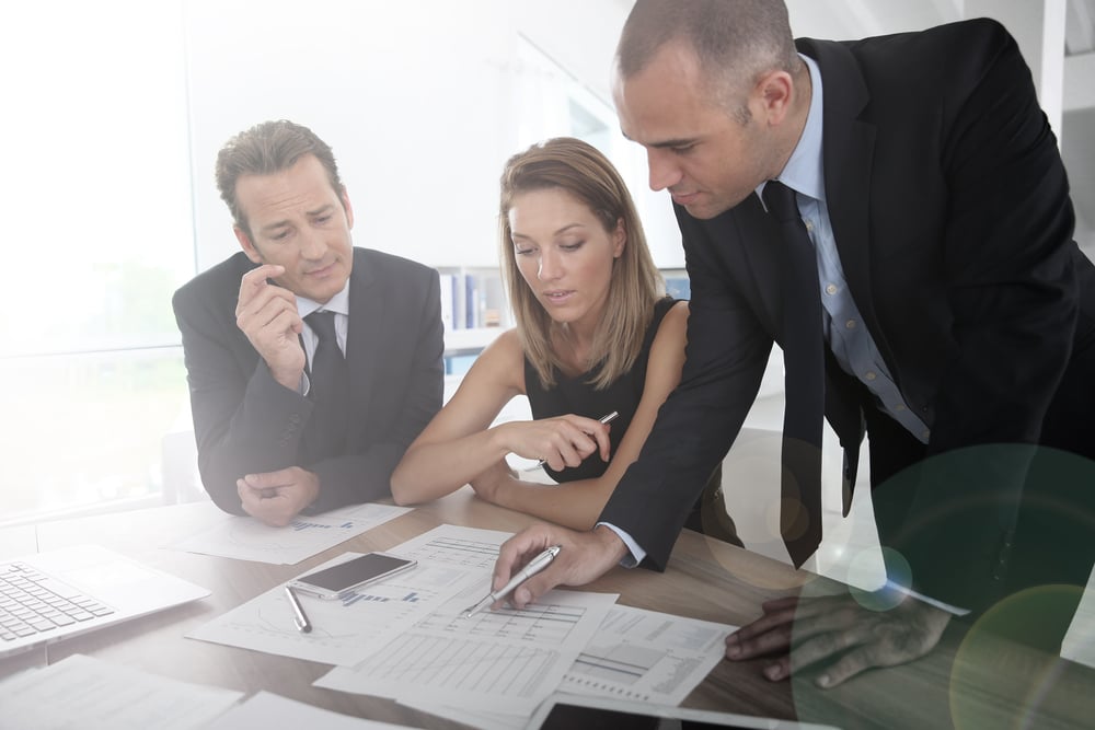 Business people looking at budget forecast Business people looking at budget forecast
